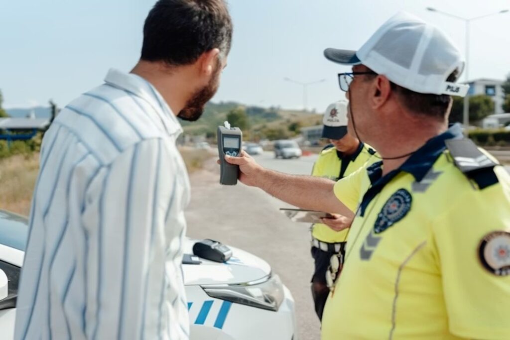 An officer showing a driver the result of his BAC test on a breathalyzer